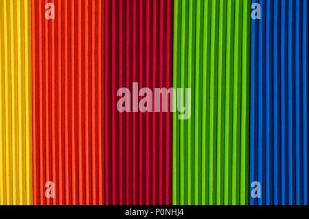 Close-up of multicolored foam craft sticks creating abstract background patterns. Stock Photo