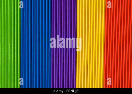 Close-up of multicolored foam craft sticks creating abstract background patterns. Stock Photo