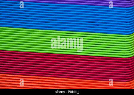 Close-up of multicolored foam craft sticks creating abstract background patterns. Stock Photo
