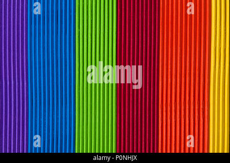 Close-up of multicolored foam craft sticks creating abstract background patterns. Stock Photo