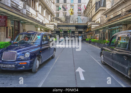 The Strand, London, UK - April 22, 2018: Entrance to The Savoy Hotel in the Strand with people and taxis. Stock Photo