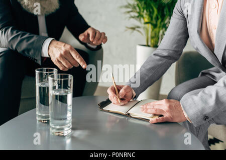 cropped view of hands of business colleagues having conversation in office Stock Photo