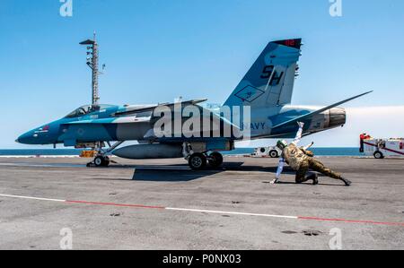 180607-N-UV609-0037 ATLANTIC OCEAN (May 14, 2018) Marines attached to the Marine Fighter Attack Training Squadron (VMFAT) 101 launch a F/A-18E Super Hornet aboard the aircraft carrier USS George H.W. Bush (CVN 77). The ship is underway conducting routine training exercises to maintain carrier readiness. (U.S. Navy photo by Mass Communication Specialist 2nd Class David Mora Jr.) Stock Photo