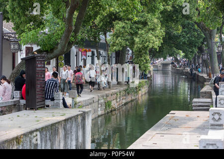 Suzhou, Jiangsu, China.  Visitors Walking along Canal Passing through Tongli Ancient Town near Suzhou. Stock Photo