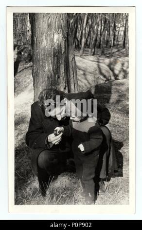 HODONIN, THE CZECHOSLOVAK REPUBLIC, CIRCA 1941: Vintage photo shows a small girl with her uncle in nature, circa 1941 Stock Photo