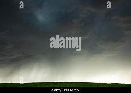 small storm rolling in over a farm Stock Photo