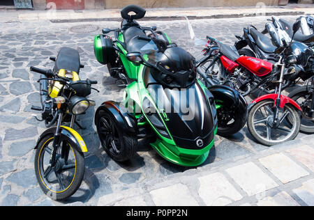 Trike motorbike and two-wheel motorbikes parked on a street in San Miguel de Allende Stock Photo