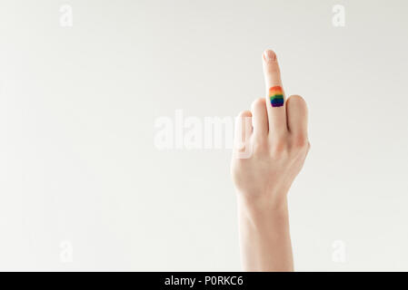 Cropped image of female middle finger with painted rainbow flag isolated on white Stock Photo