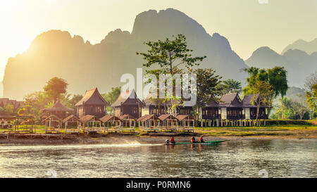 Village and bungalows along Nam Song River in Vang Vieng, Laos. Stock Photo