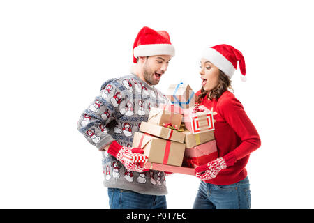 happy young couple holding stacks of christmas gifts isolated on white Stock Photo