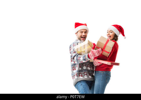 happy young couple holding stacks of christmas gifts isolated on white Stock Photo