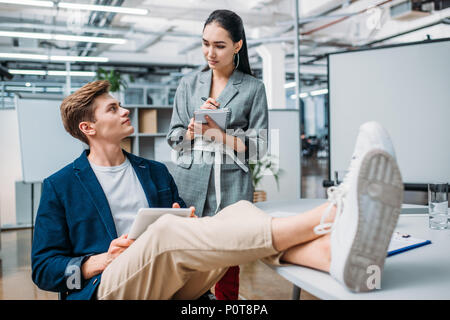 Boss and his beautiful secretary working in office Stock Photo - Alamy