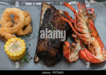Surf and Turf, grilled canadian lobster and grilled beef ribs Stock Photo