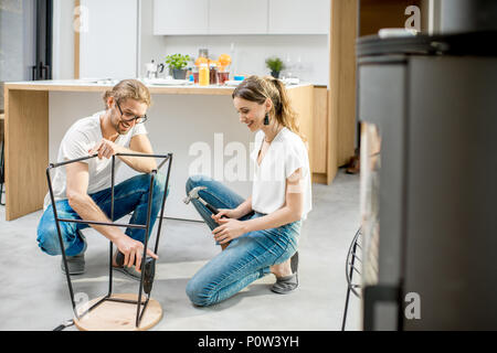 Couple doing house chores at the modern apartment Stock Photo