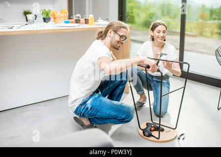 Couple doing house chores at the modern apartment Stock Photo