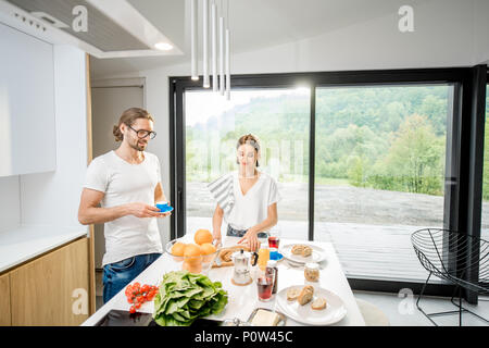Young couple having breakfast at home Stock Photo