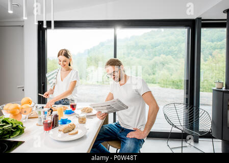 Young couple having breakfast at home Stock Photo