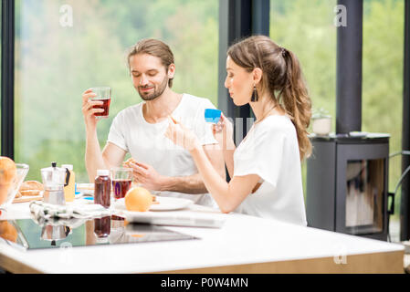 Young couple having breakfast at home Stock Photo