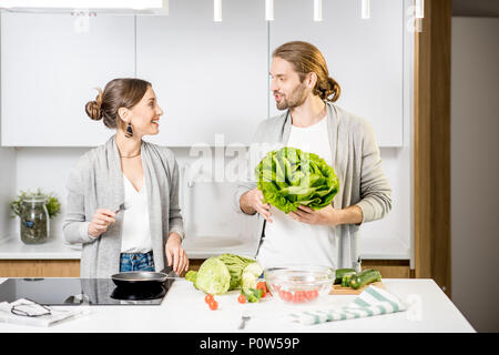 Couple cooking food at the kitchen home Stock Photo