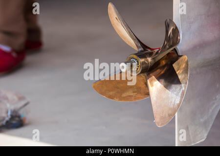 Close up image of four bladed stainless steel speed Boat Engine propeller. Stock Photo