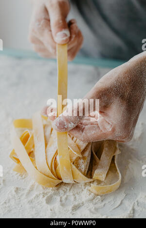 Closeup of process of making cooking homemade pasta. Chef make fresh italian traditional pasta Stock Photo