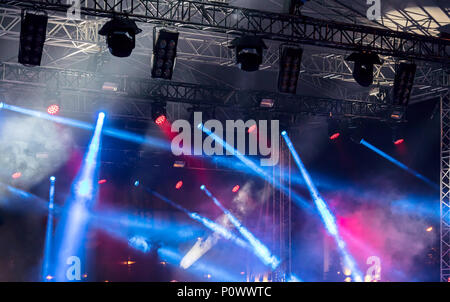 lights of professional spotlights and projectors above the stage during concert  Stock Photo