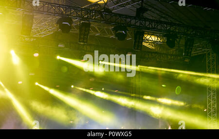 outdoor rock concert. green lightning and smoke on stage Stock Photo