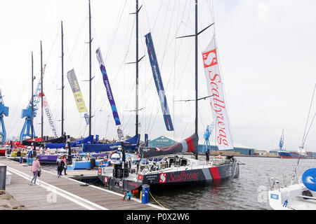 Cardiff, United Kingdom - June 08, 2018: The teams of the Volvo Ocean Race and their Volvo 65 yachts docked in the Volvo Ocean Race Village after the  Stock Photo