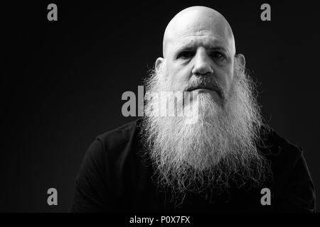 Black And White Portrait Of Mature Bald Man With Long Beard Stock Photo