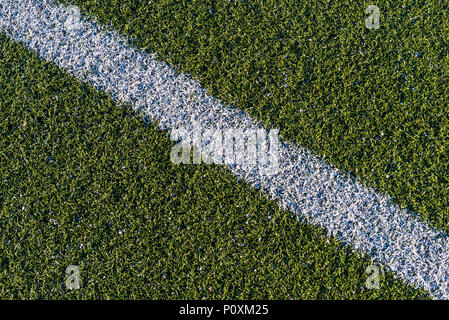 Background from a white line on a green artificial soccer field Stock Photo