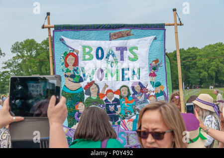 Edinburgh, Scotland, UK. 10th June, 2018. Women holding an artwork banner that reads Boats For Women at the start of the Edinburgh Processions Artwork march celebrating 100 years since British women won the right to vote. Thousands of women came together in the four capitals of the UK,  Belfast, Cardiff, Edinburgh and London. The Participants wore either a green, white or violet scarf and walked in stripes through the city streets to depict the colours of the suffragettes. Credit: Skully/Alamy Live News Stock Photo