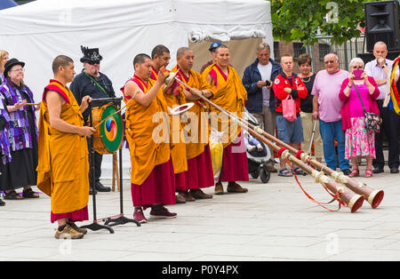 Wimborne, Dorset, UK. 10th June 2018. Crowds flock to Wimborne Folk Festival for a day of fun watching the dancers and listening to the music. Tashi Lhunpo Monks from Tashi Lhunpo Monastery perform traditional Tibetan festival dances and play Tibetan horns and drum. Credit: Carolyn Jenkins/Alamy Live News Stock Photo