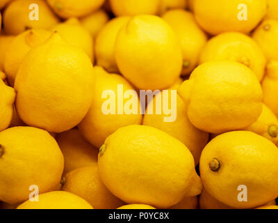Closeup Colorful Display Of Lemons In Market. Background Stock Photo