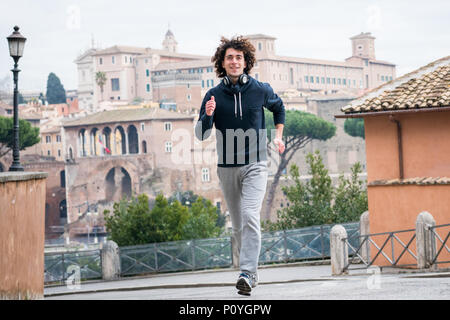Handsome young sportsman jogging in Rome city Stock Photo
