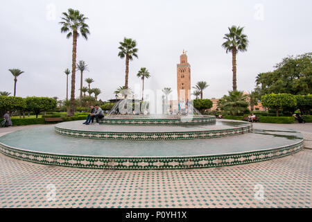 Marrakesh, Morocco - November 08, 2017: View of the Koutoubia Mosque in Marrakesh from Lalla Hasna park with fountain and palm trees in the foreground Stock Photo
