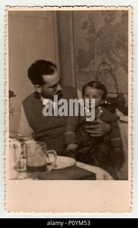 HODONIN, THE CZECHOSLOVAK REPUBLIC, CIRCA 1941: A vintage photo shows father with small girl, circa 1941. Stock Photo