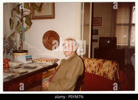 THE CZECHOSLOVAK SOCIALIST REPUBLIC, CIRCA 1980s: Vintage photo shows man sits on chair, circa 1980s. Stock Photo