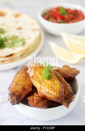 Homemade delicious food of tortillas, salsa and fried wings. Selective focus. Stock Photo