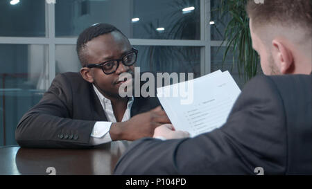 Businesspeople working together on project in office Stock Photo