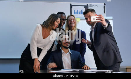 Multiracial team taking selfie at business meeting Stock Photo
