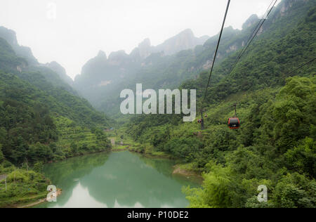 The longest cableway in the world, landscape view with the lake, mountains, green forest and mist - Tianmen Mountain, The Heaven's Gate at Zhangjiagie Stock Photo