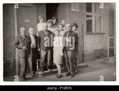 THE CZECHOSLOVAK SOCIALIST REPUBLIC, CIRCA 1970s: Vintage photo shows group of people in front of building. Stock Photo