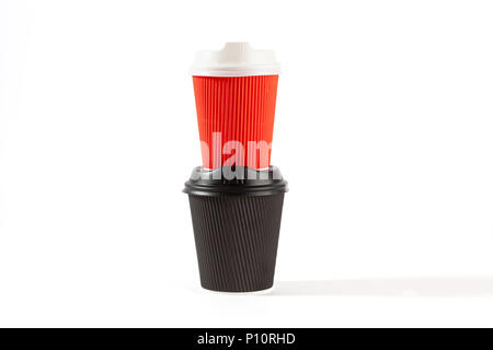 Red and black plastic coffee cups stacked on top of each Stock Photo