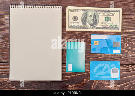 Blank notepad with money and credit cards. Money account concept. Top view, flat lay. Stock Photo