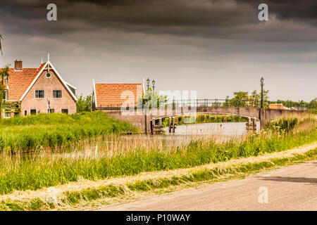 Typical canal landscape and bridge entrance to rural village in the Dutch countryside. oterleek netherlands Stock Photo