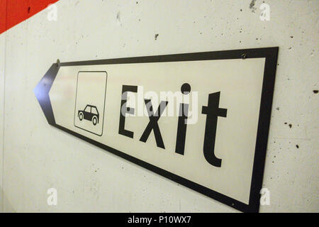 Exit sign pointing towards way out of car park in Tasch, Switzerland Stock Photo