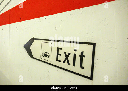 Exit sign pointing towards way out of car park in Tasch, Switzerland Stock Photo
