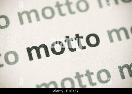 word motto printed on white paper macro Stock Photo