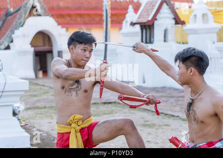 Thai ancient warrior swordsmanship fighting action with sword and spear weapon in Northern Lanna culture and Arts show in 14 January 2017 Lampang Thai Stock Photo