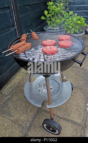 Dangers of food poisoning from summer BBQ meat, Sausages, beef burgers, Kebabs, under-cooked or raw Stock Photo